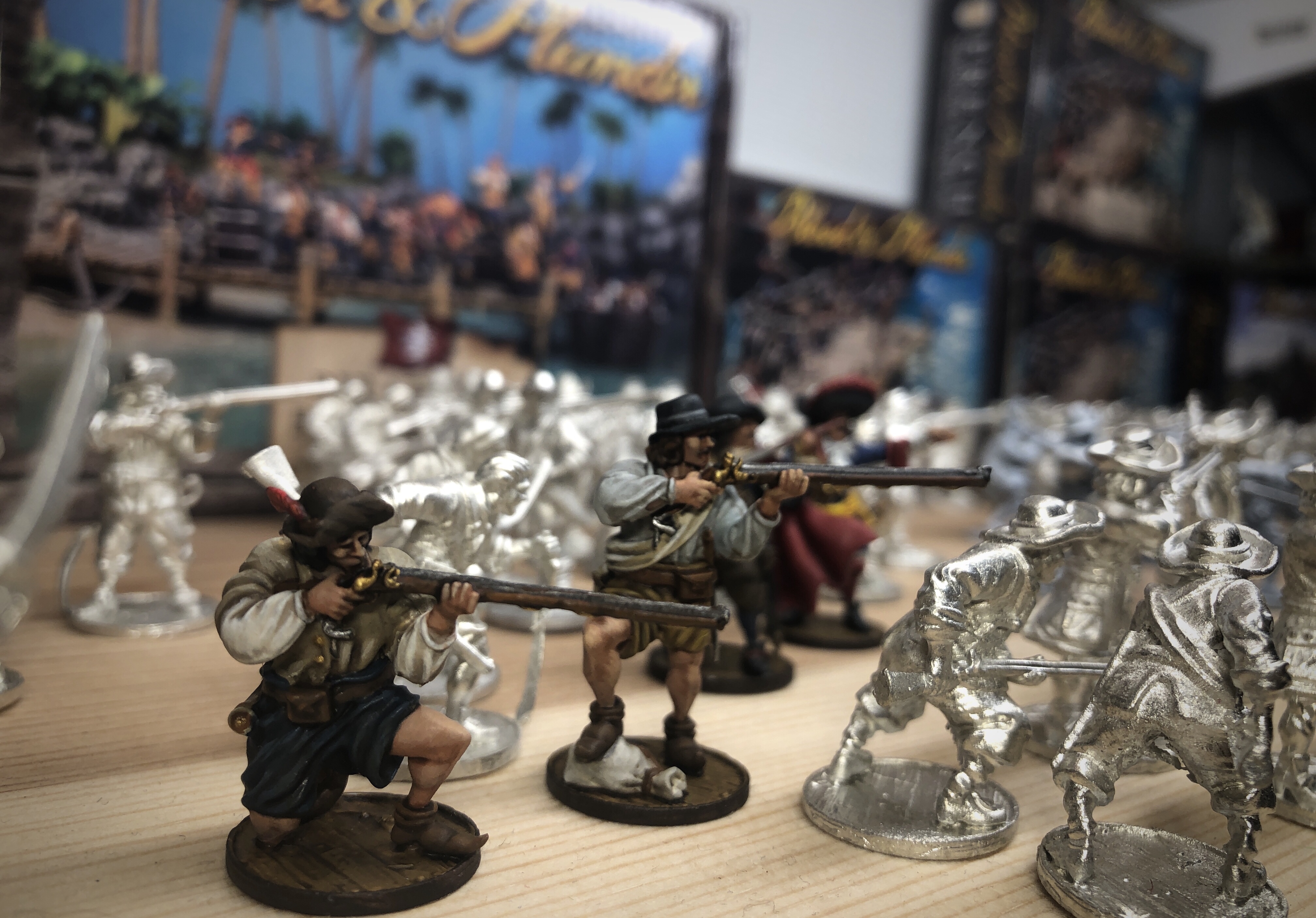 Table full of Blood & Plunder miniatures, starter boxes in the background