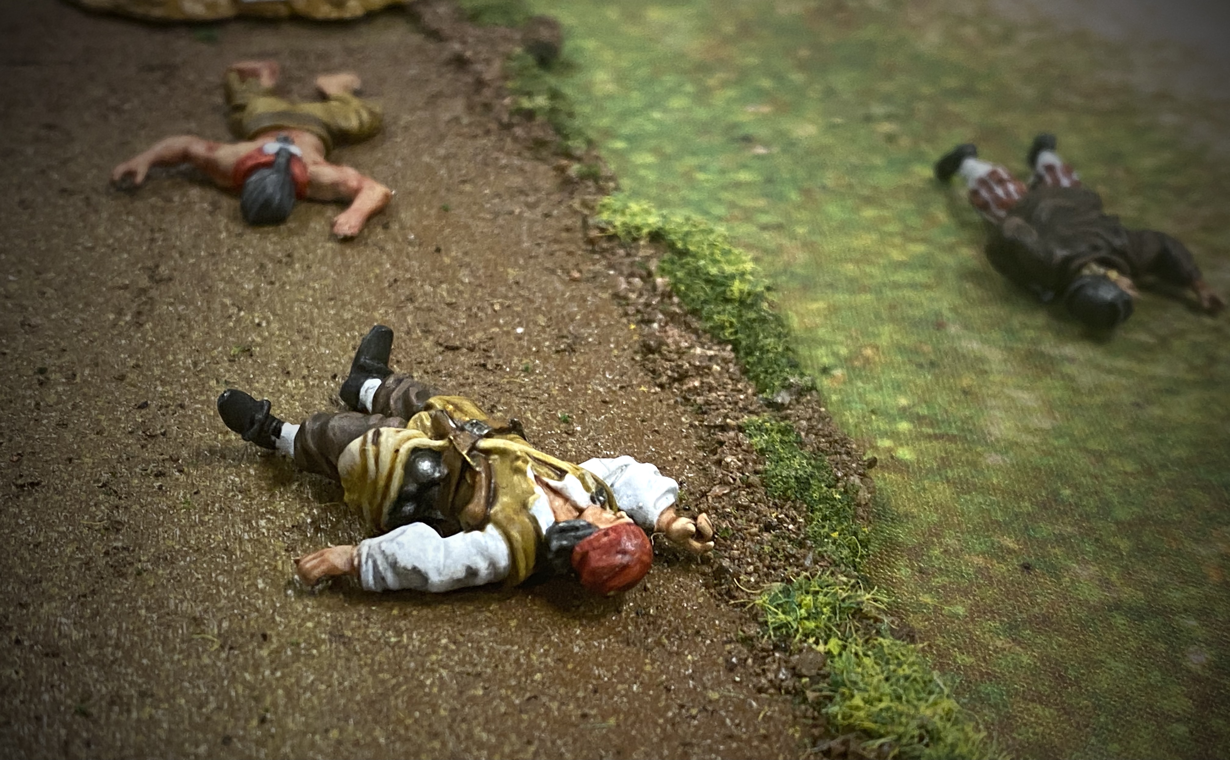 3 Blood & Plunder Casualty Markers on a battlefield