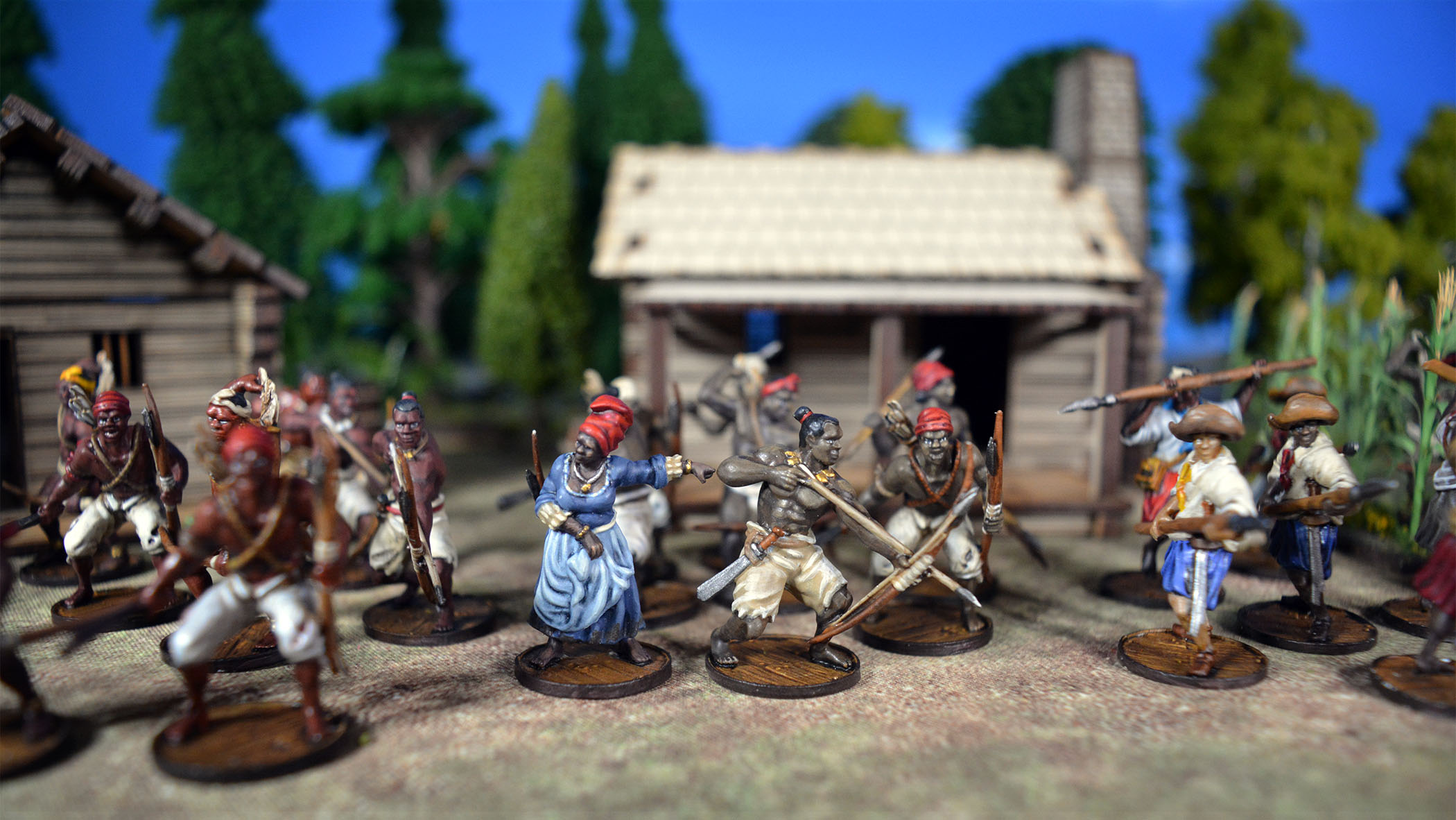 Local Guide female African and African Warriors in front of a cabin
