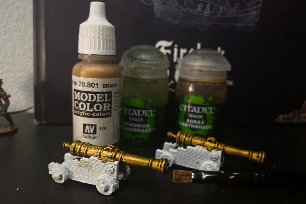 Paint bottles for the colors used on the cannon barrel