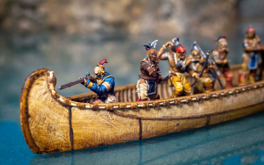 Blood & plunder birchbark canoe full of Native American braves