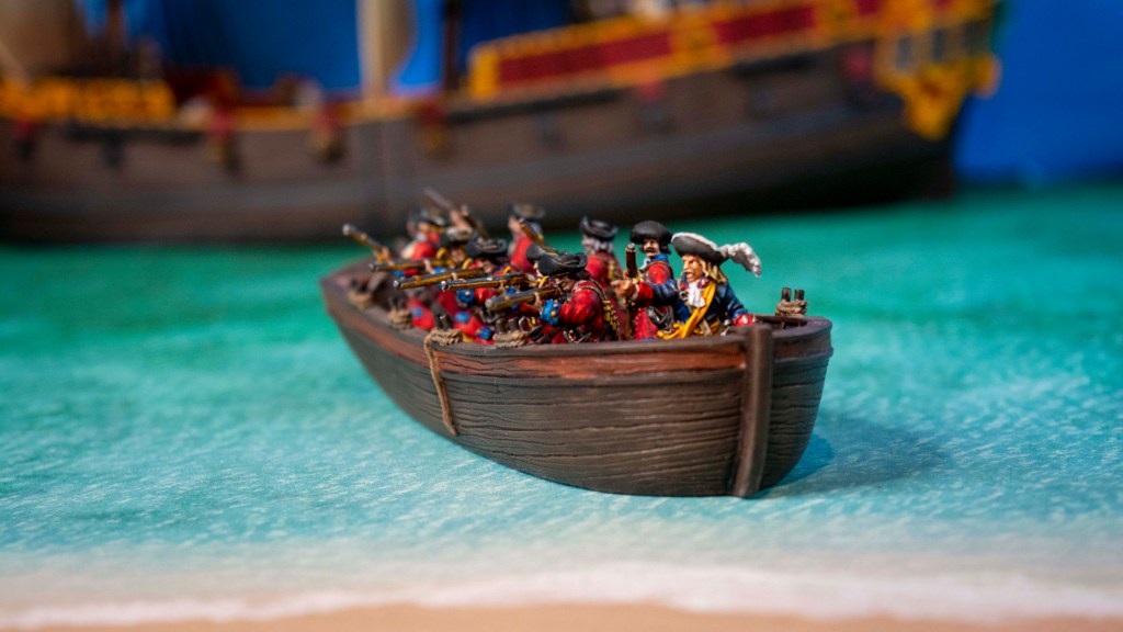 Blood & Plunder English Minis in a longboat coming ashore from a 6th Rate Frigate in the background