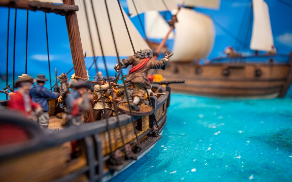 Blackbeard ordering his crew to use swivel guns on an enemy ship