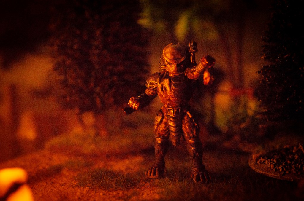 A Predator hunter at night by firelight