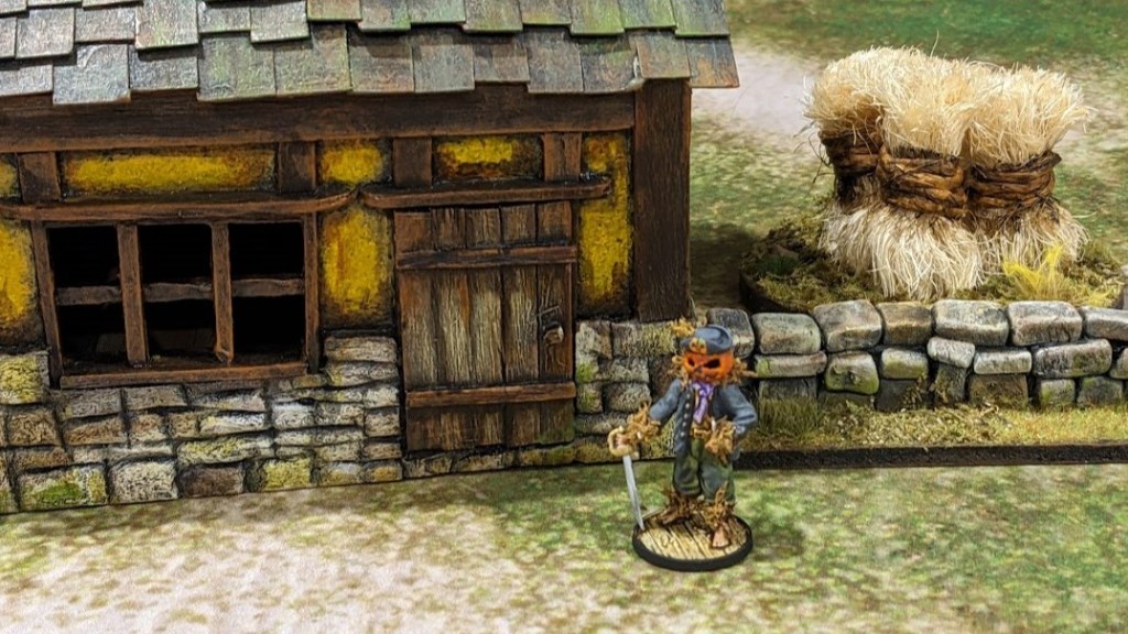The Headless Seaman , miniature cottage , stone wall and hay stack.