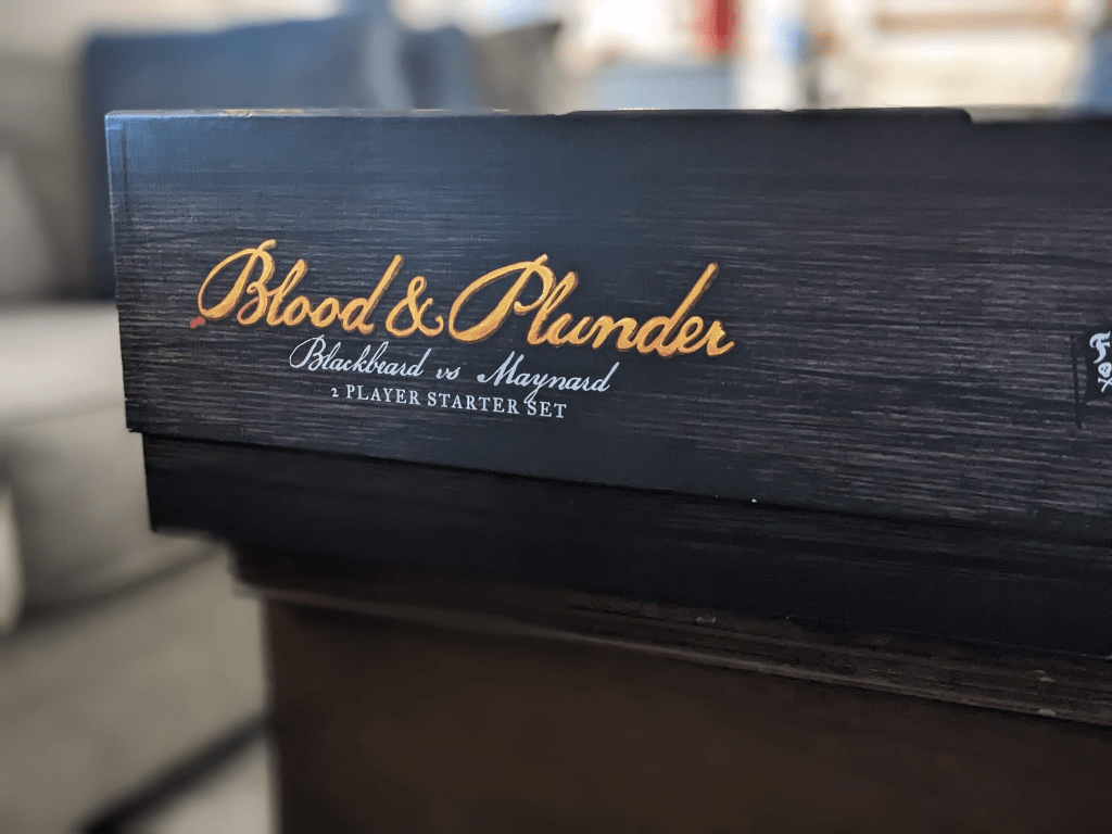 2 Player Blodd & Plunder starter box with a raised lid due to braces extending the height