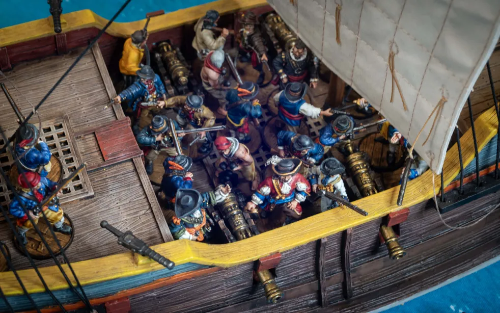 Fluyt ship model loaded with Blood & Plunder minis and Heavy guns