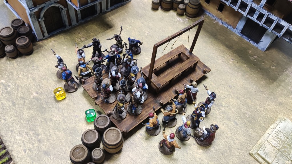 Blood & Plunder minis fighting near the gallows in a town square