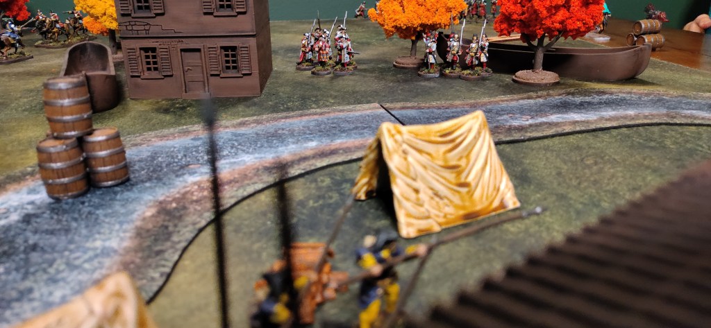 Blood & Plunder minis along a river bed with a tent