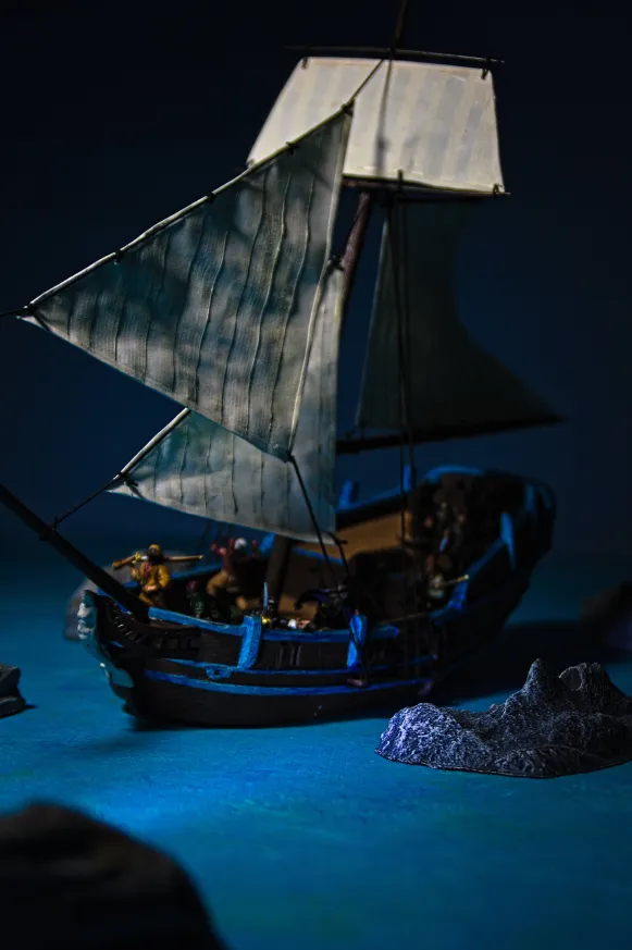 Sloop sailing at night through rocky  waters