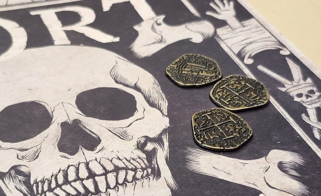 Port Royal rulebook cover and 3 fortune coins