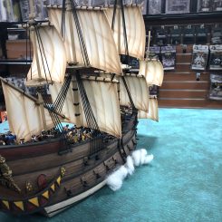 Fully painted and figged Galleon ship on a Tablewar Fat Mat in a game store