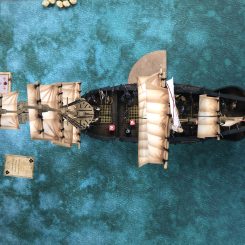 Galleon model top down view on gaming table with cards and markers