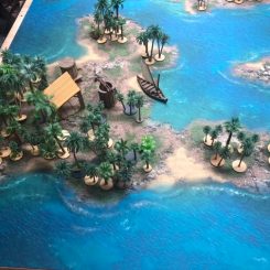 palm trees on a wargaming table islands with ships and buildings